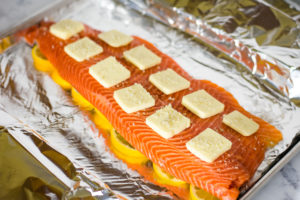 salmon with butter pats on top