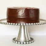 Chocolate Layer Cake sitting on a cake stand