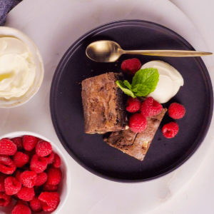 Brownies with raspberries, ice cream, and mint