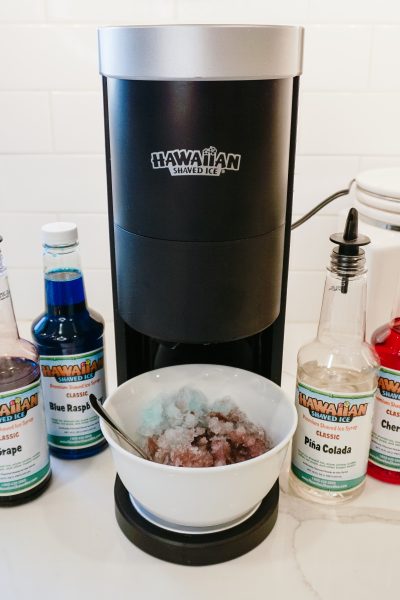 Hawaiian Shaved Ice Machine on countertop with syrups around it