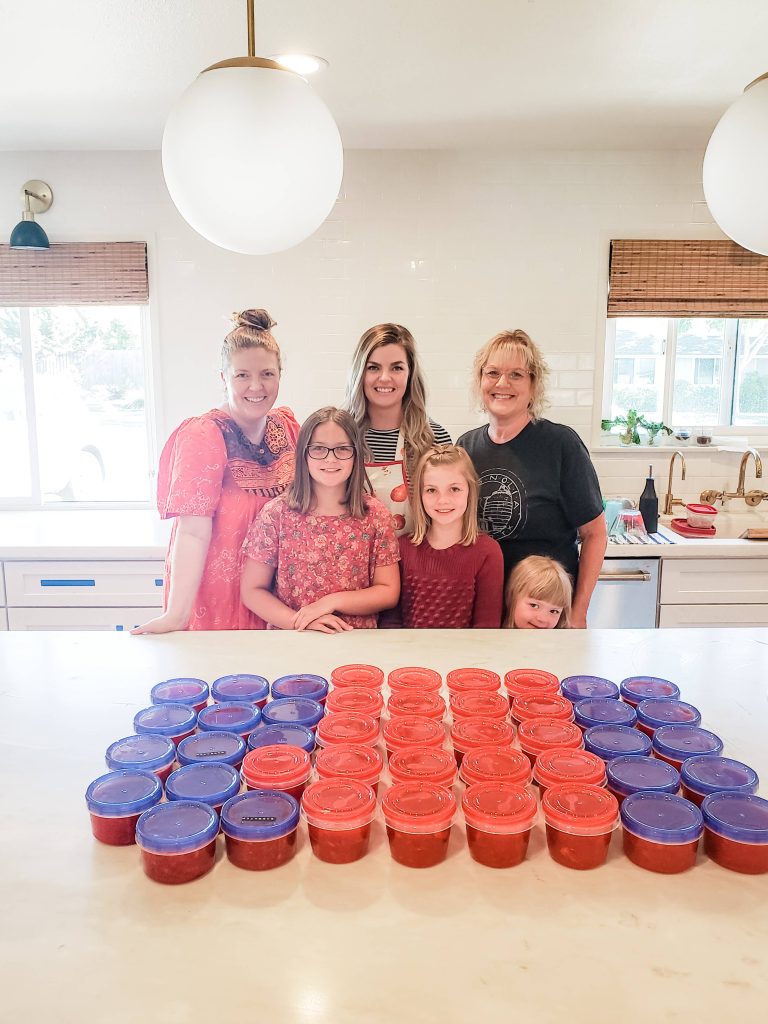 three generations of women make strawberry freezer jam